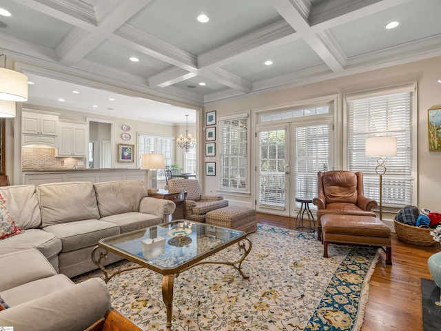 living room featuring ornamental molding, coffered ceiling, beam ceiling, and wood finished floors