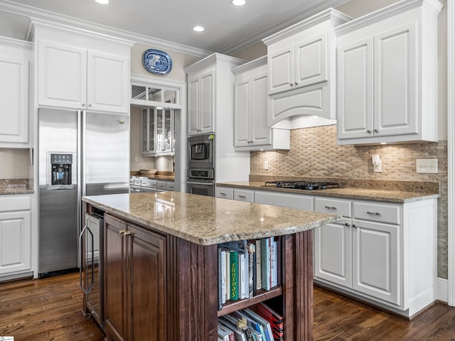 kitchen with dark wood-type flooring, white cabinets, appliances with stainless steel finishes, a center island, and open shelves