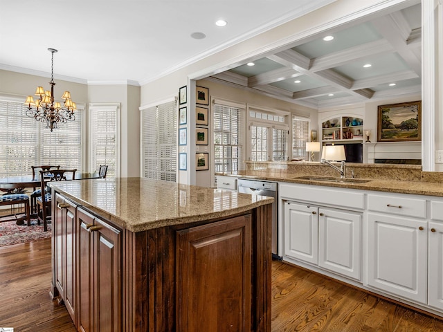 kitchen featuring coffered ceiling, a sink, dishwasher, beamed ceiling, and dark wood finished floors