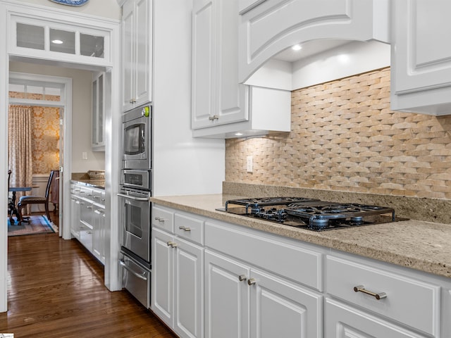 kitchen with white cabinetry, custom exhaust hood, stainless steel appliances, and a warming drawer