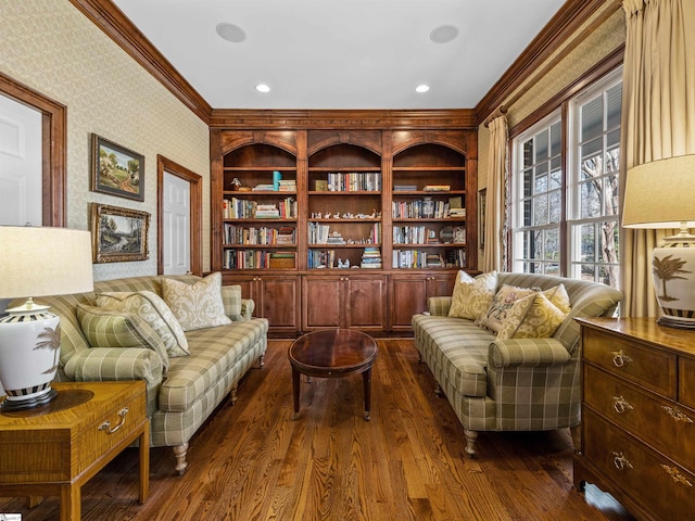 living area with dark wood finished floors, crown molding, recessed lighting, and wallpapered walls