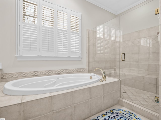 bathroom featuring a garden tub, a shower stall, and crown molding