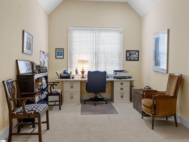 home office with light colored carpet, vaulted ceiling, and baseboards