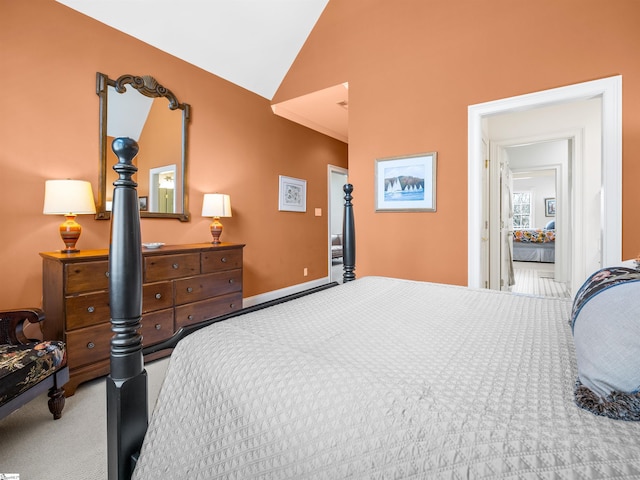 carpeted bedroom with vaulted ceiling