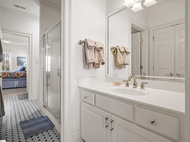 ensuite bathroom featuring ensuite bathroom, ornamental molding, a stall shower, and vanity