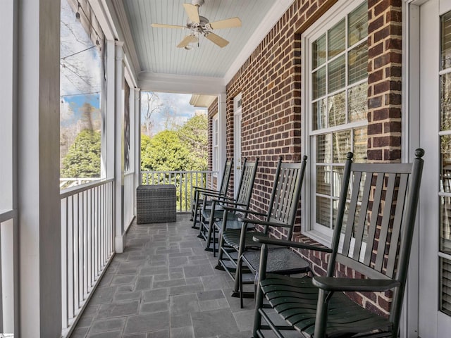 balcony featuring ceiling fan and a porch