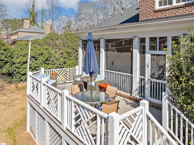 wooden terrace featuring outdoor dining space