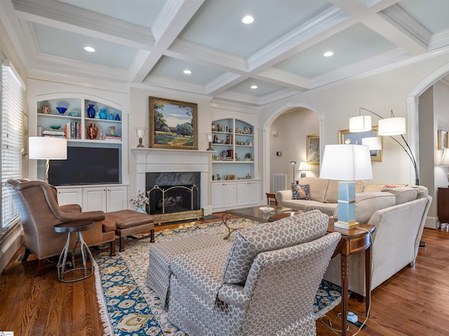 living room featuring arched walkways, a premium fireplace, wood finished floors, coffered ceiling, and beamed ceiling