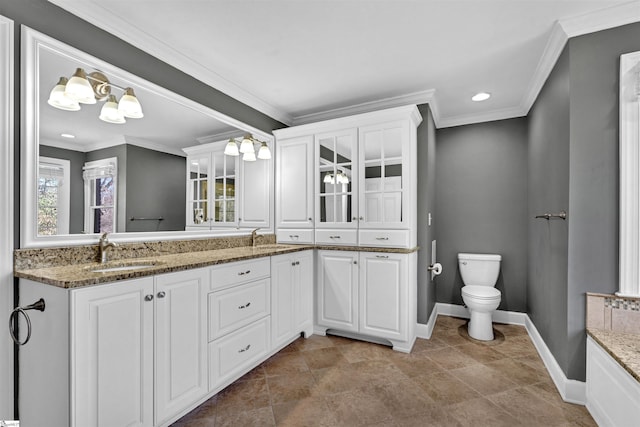 full bathroom featuring ornamental molding, baseboards, vanity, and toilet