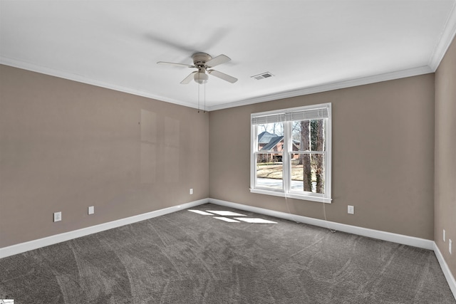 spare room featuring carpet floors, crown molding, visible vents, a ceiling fan, and baseboards