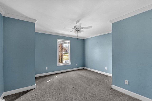 carpeted empty room featuring a ceiling fan, crown molding, and baseboards