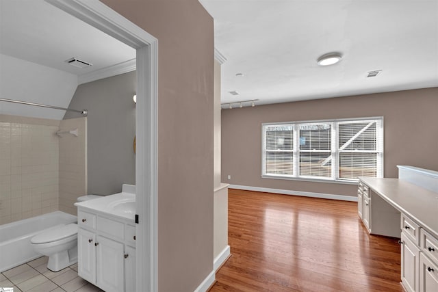 full bathroom featuring visible vents, vanity, toilet, and bathing tub / shower combination