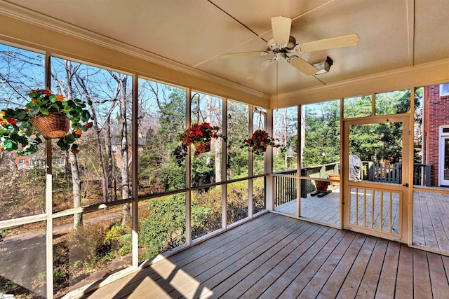 unfurnished sunroom with a ceiling fan