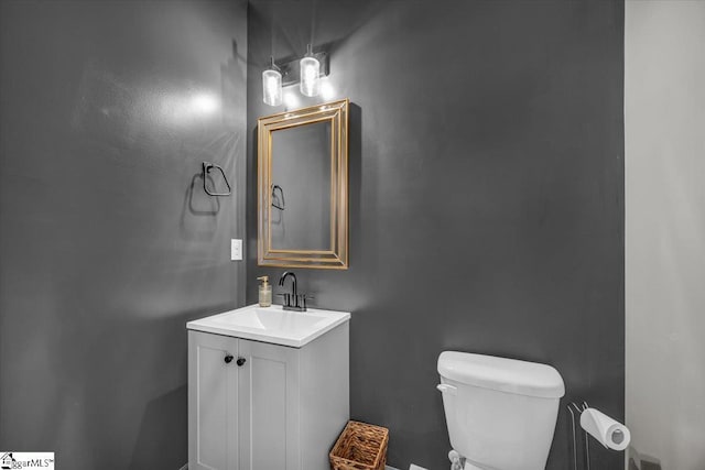 half bath featuring toilet and vanity