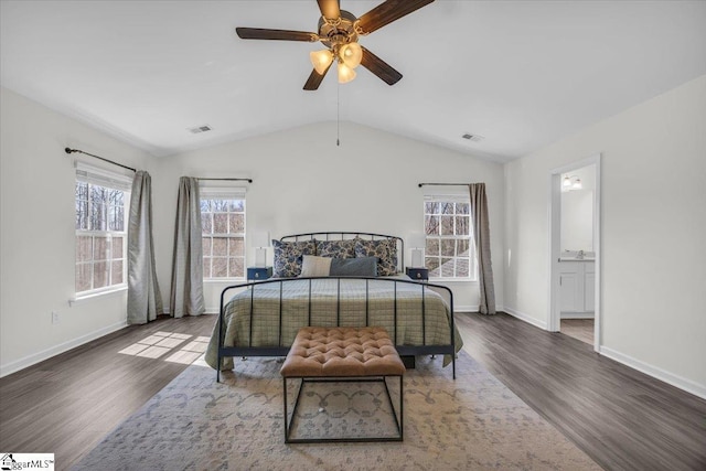 bedroom featuring vaulted ceiling, wood finished floors, visible vents, and baseboards