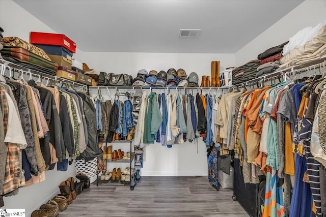 walk in closet featuring wood finished floors and visible vents