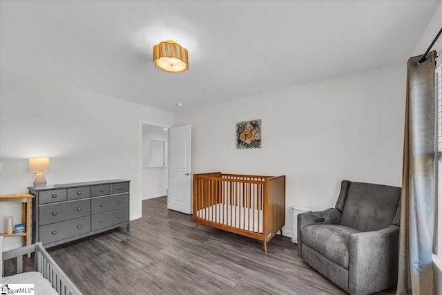 bedroom with baseboards and wood finished floors