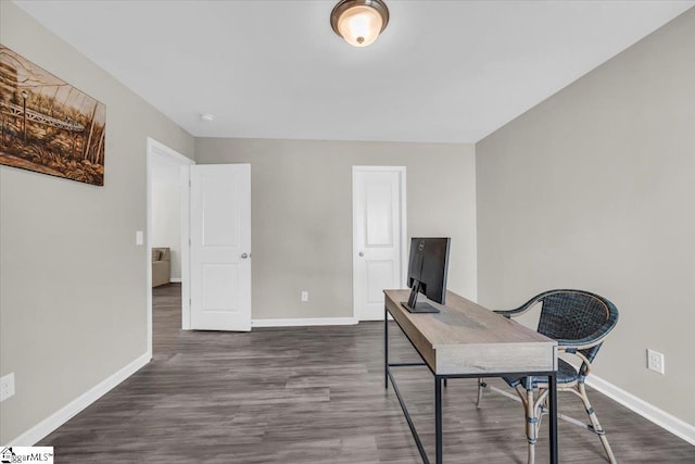 office featuring baseboards and dark wood-type flooring