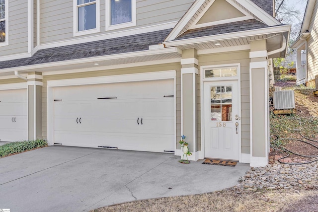 garage featuring driveway and central air condition unit