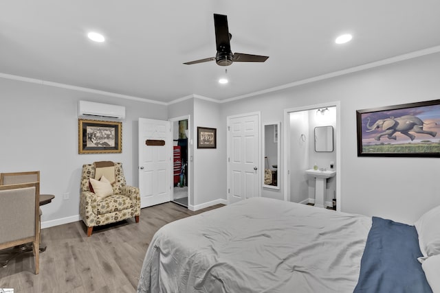 bedroom featuring a wall mounted air conditioner, crown molding, baseboards, and wood finished floors