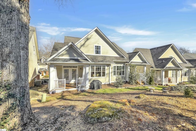 view of front facade with a porch, french doors, and central AC