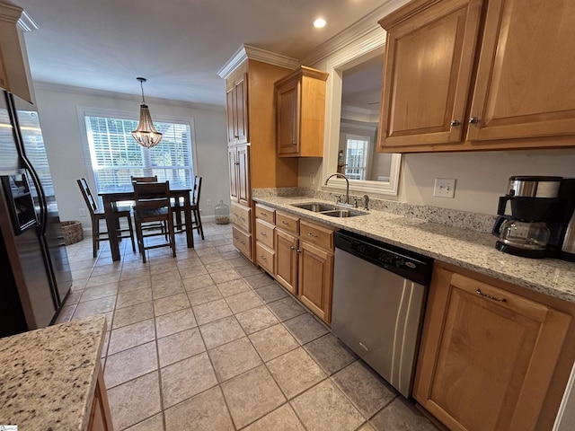 kitchen with light stone countertops, black fridge, crown molding, stainless steel dishwasher, and a sink