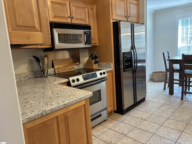 kitchen with stainless steel appliances, ornamental molding, light stone counters, and light tile patterned floors