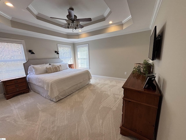 bedroom featuring light carpet, a tray ceiling, recessed lighting, and baseboards