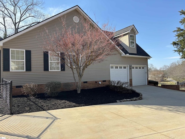 view of home's exterior with crawl space, driveway, a shingled roof, and an attached garage