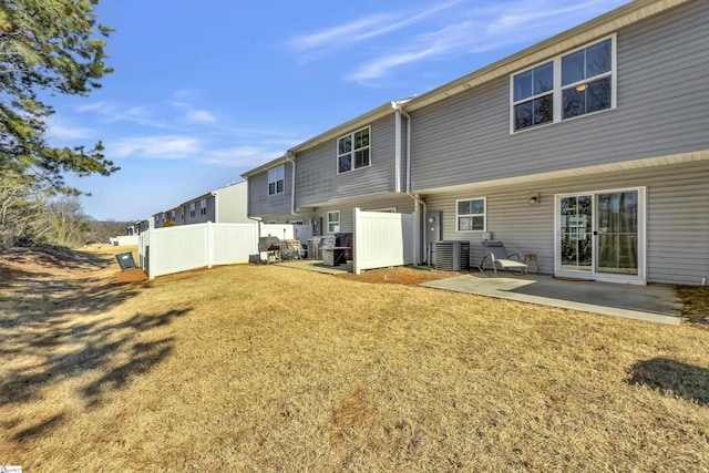 rear view of house with a patio, a yard, fence, and central air condition unit