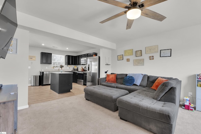 living area featuring a ceiling fan, recessed lighting, light carpet, and baseboards