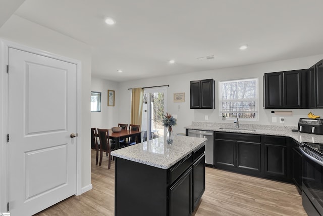 kitchen with dark cabinets, range with electric cooktop, light wood-type flooring, and dishwasher