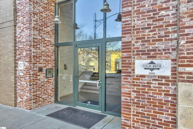 view of exterior entry with brick siding