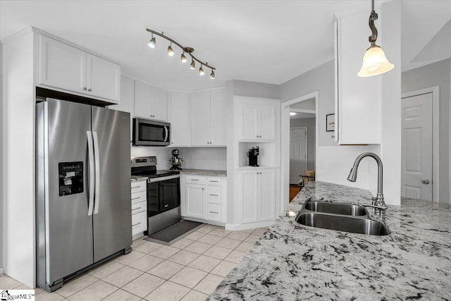 kitchen featuring decorative backsplash, appliances with stainless steel finishes, light stone countertops, white cabinetry, and a sink