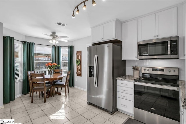 kitchen with stainless steel appliances, visible vents, decorative backsplash, white cabinetry, and ceiling fan