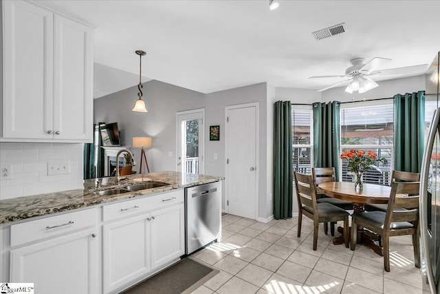 kitchen featuring a sink, visible vents, white cabinets, appliances with stainless steel finishes, and tasteful backsplash