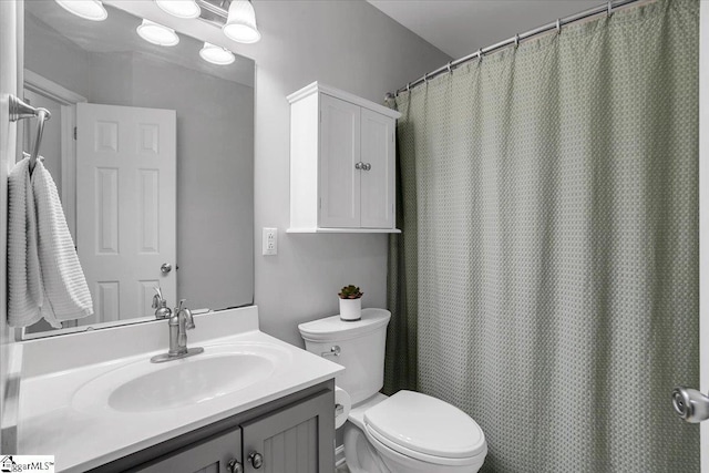 bathroom with toilet and vanity