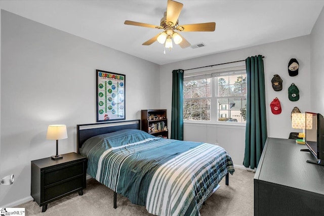 bedroom featuring a ceiling fan, light carpet, visible vents, and baseboards