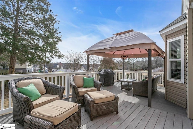 wooden terrace with a grill and outdoor lounge area