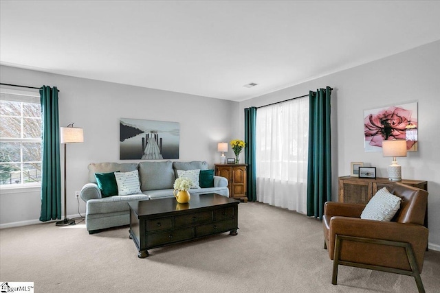 carpeted living room featuring baseboards