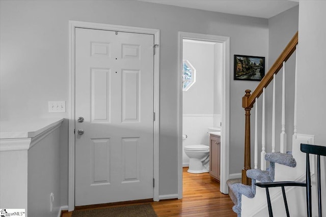 foyer with light wood-style floors and stairway