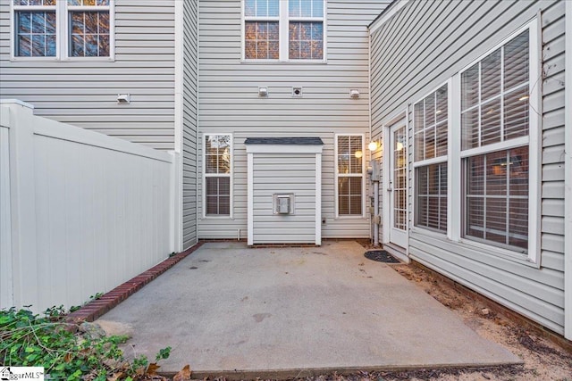 doorway to property featuring a patio and fence