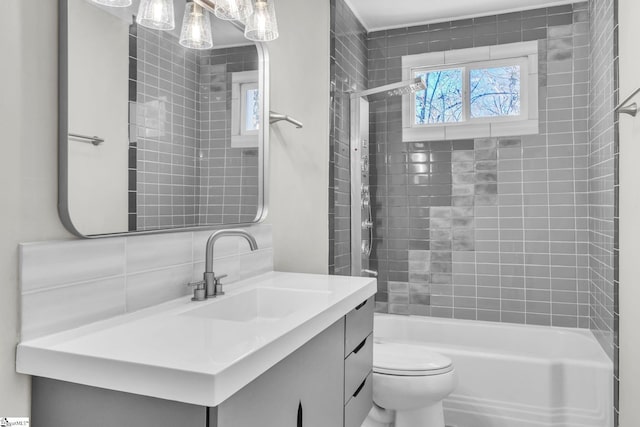 bathroom with tub / shower combination, vanity, toilet, and decorative backsplash