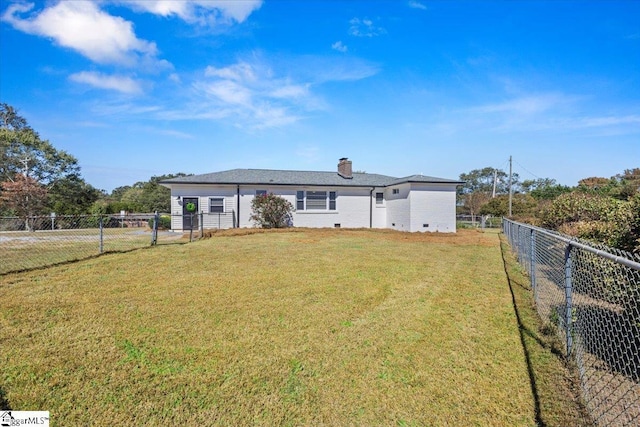 single story home featuring a chimney, a front yard, and a fenced backyard