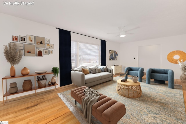 living area featuring light wood-style flooring and ceiling fan