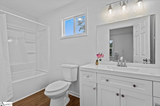 full bath with baseboards, toilet, wood finished floors, shower / bathtub combination with curtain, and vanity