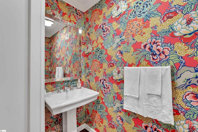 bathroom with wallpapered walls