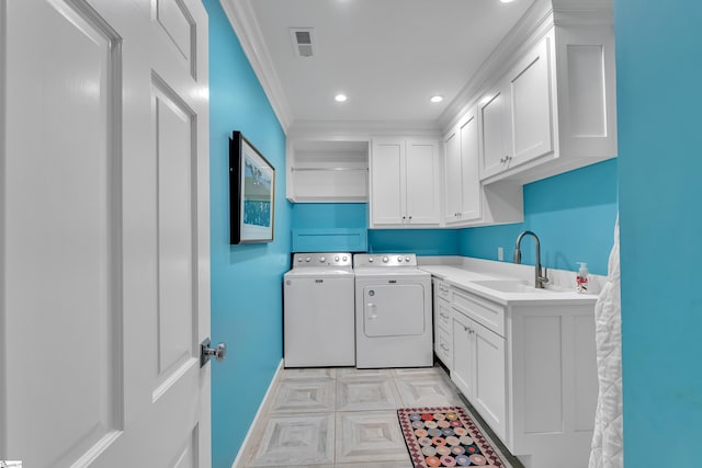 laundry area featuring cabinet space, visible vents, ornamental molding, a sink, and independent washer and dryer