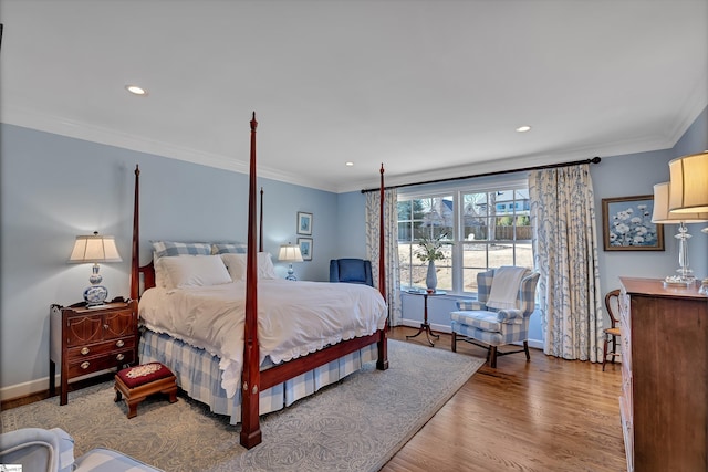 bedroom featuring ornamental molding, wood finished floors, and baseboards