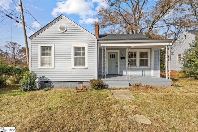 bungalow-style home with crawl space, covered porch, a front lawn, and roof with shingles